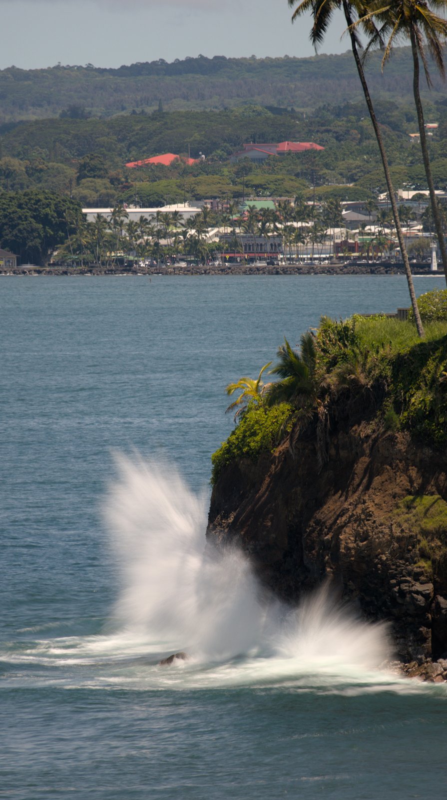 Wave crash near outcropping at Honolii Beach