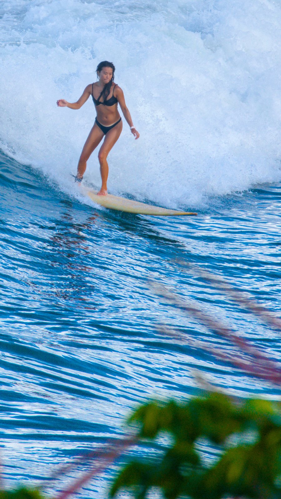 Woman surfing at Honolii