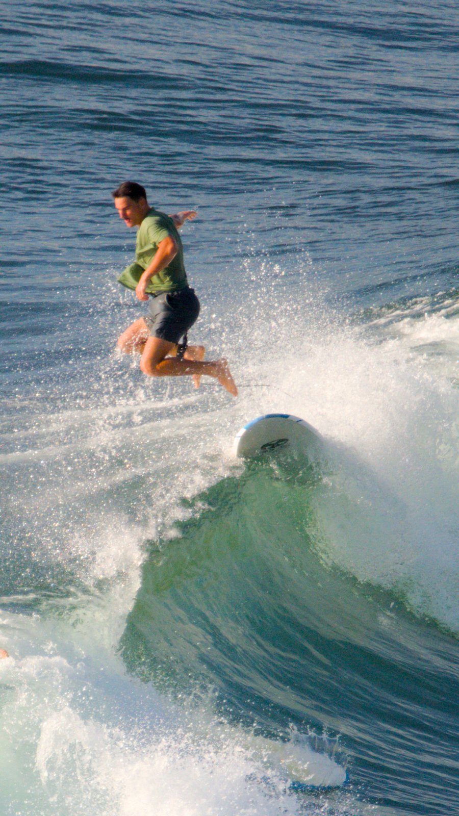 Man jumps off surfing board