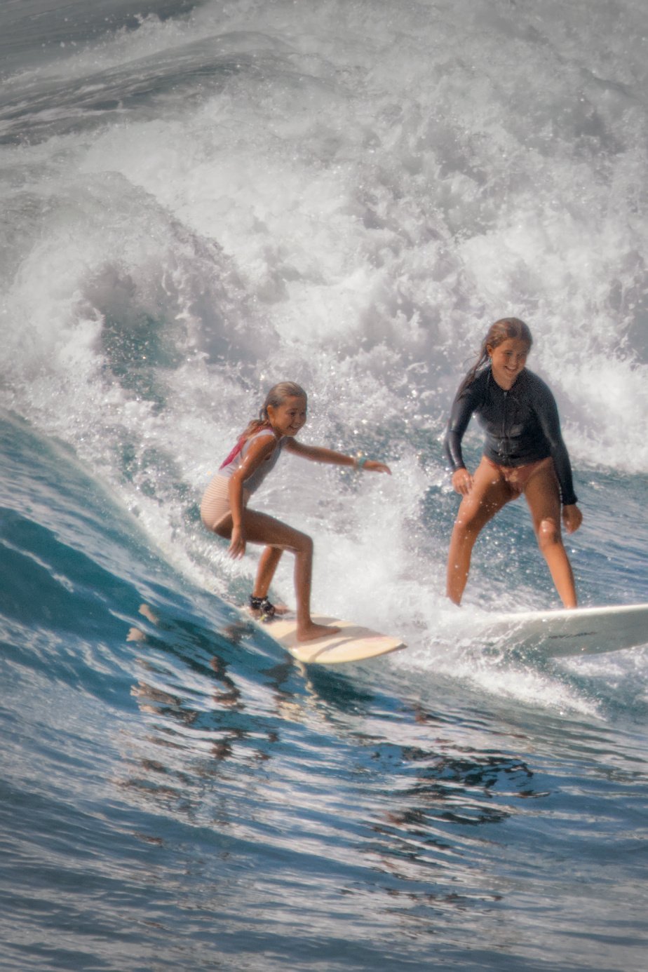 Girls surfing at Honolii